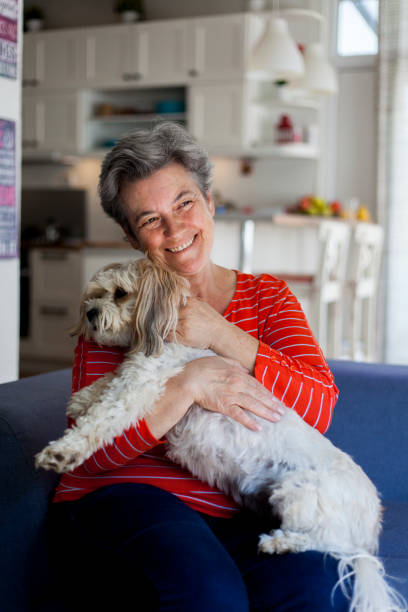 istock senior woman having fun with her dog 1044472470