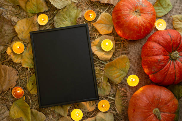 istock Pumpkin with candles and a frame for writing. Halloween 1044480014