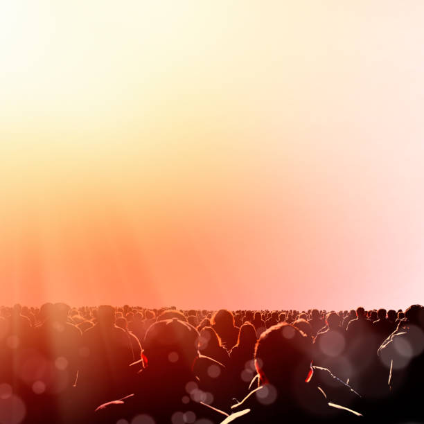 Crowd of people walking over sky with light beam
