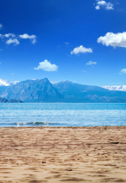 istock Sandy beach and high mountains over clear sky 1044483358