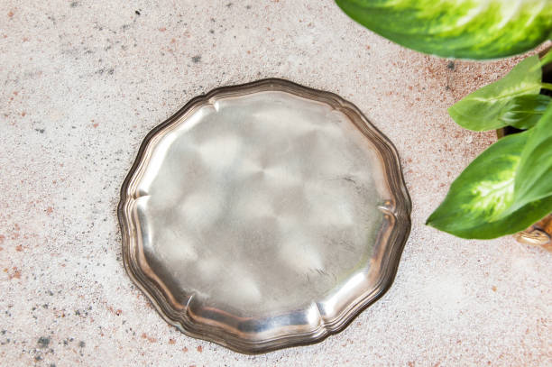 istock Vintage silverplate dish and green plants 1044485954