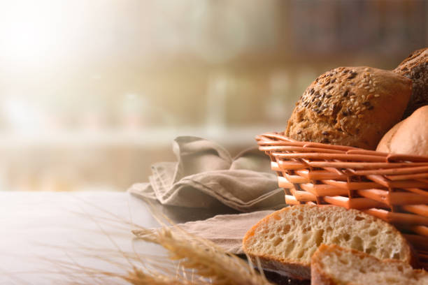 istock Basket with bread on black wooden table front 1044492792