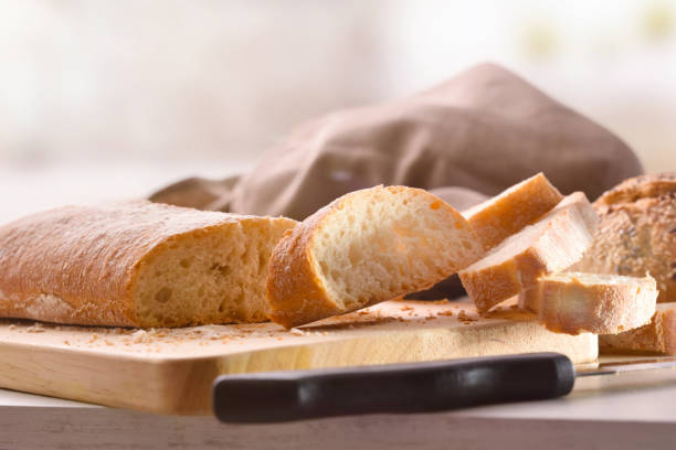 istock Bread cut into slices on cutting board of a kitchen 1044492802