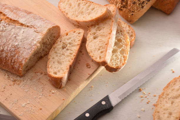 istock Bread cut into slices on cutting board of kitchen top 1044492820