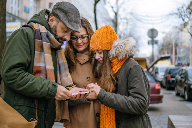 Family using smartphone for find a way in city