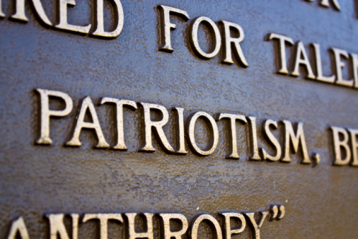 Focus on a metal inscription of the word Patriotism.