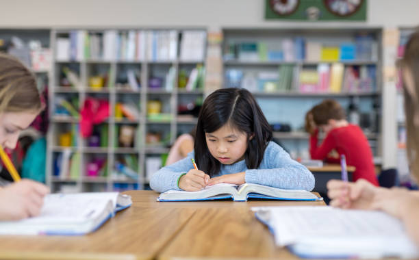 istock A 4th grade girl works at her classroom desk 1044495540