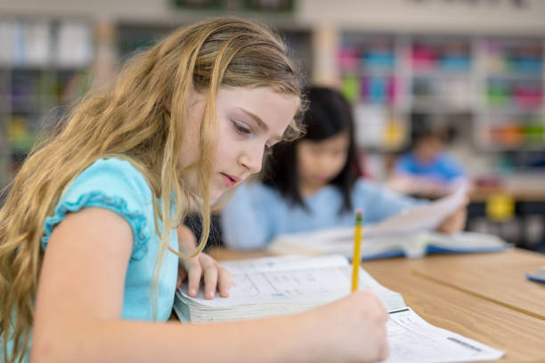istock 4th grade girls studying in the classroom 1044495550