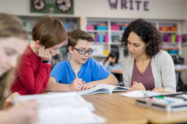 istock Teacher helping 4th graders in her classroom 1044495568