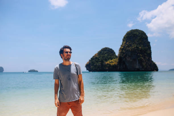 istock Young man relaxing at the popular Railay beach in Thailand 1044496548