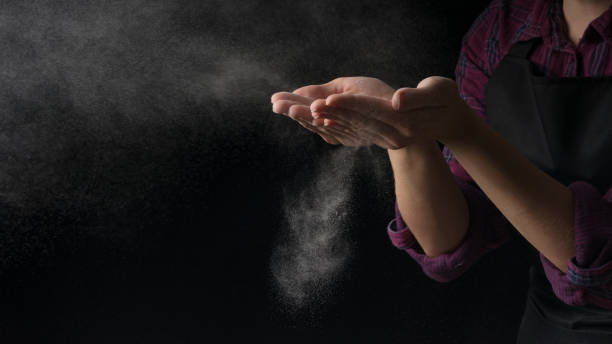 istock Cook hands in flour on a black banner background. Making pizza, pasta, baking bread and sweets. With an empty place for inscription or advertising 1044501568