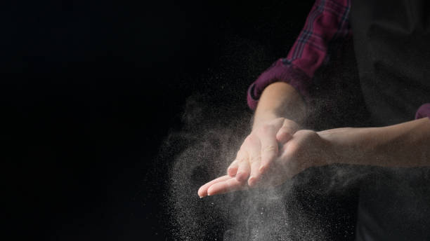 istock Cook hands in flour on a black banner background. Making pizza, pasta, baking bread and sweets. With an empty place for inscription or advertising 1044503710