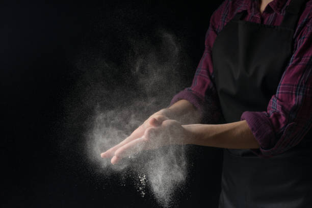 istock Cook hands in flour on a black banner background. Making pizza, pasta, baking bread and sweets. With an empty place for inscription or advertising 1044504140