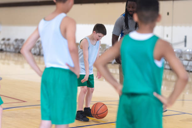 istock Coach talking with his elementary boy's basketball team 1044504148