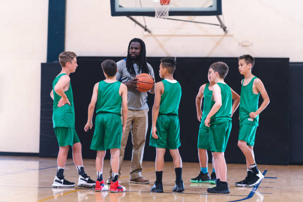 istock Coach talking with his elementary boy's basketball team 1044504154