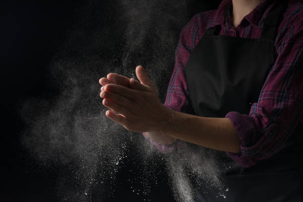 istock Cook hands in flour on a black banner background. Making pizza, pasta, baking bread and sweets. With an empty place for inscription or advertising 1044504178
