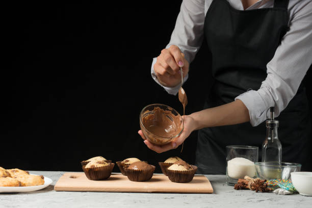 istock The chef prepares sweets, on a dark background with an empty space 1044511618