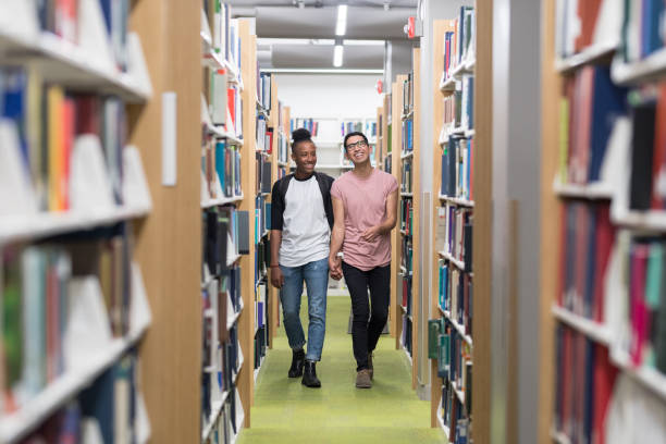 istock LGBTQ couple walking through library together 1044520606