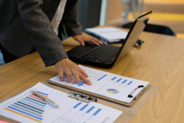 istock financial inspector analyze document at office. businesswoman working with computer at workplace 1044528376