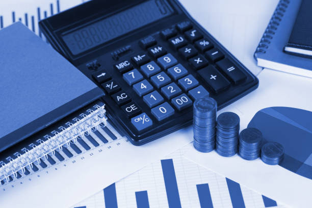 istock Coin stack and financial graph paper sheet with calculator on working table, business planning vision and finance analysis concept. 1044528702