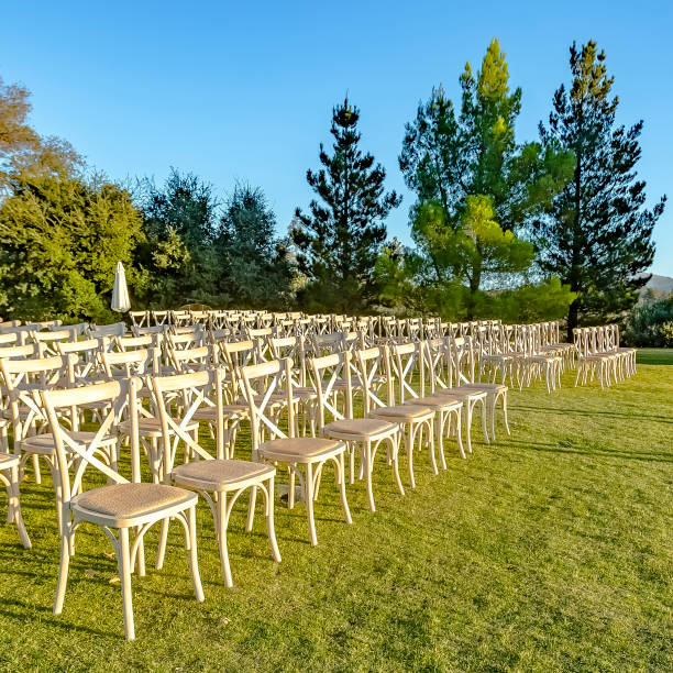 istock White chairs arranged for a sunny outdoor wedding 1044535878