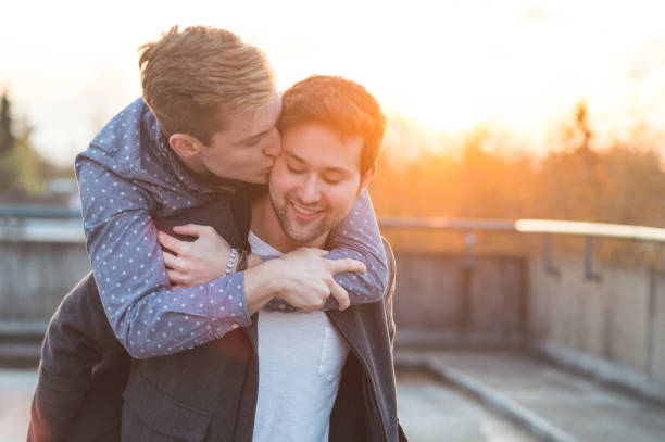 istock Affectionate male couple walking together in the evening 1044538398