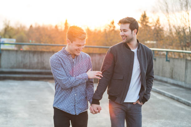 istock Affectionate male couple walking together in the evening 1044538410
