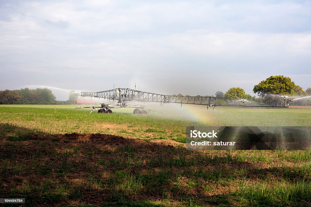 irrigation system irrigation system and rainbow Agricultural Field Stock Photo