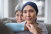 istock An Asian woman in her 60s embraces her mid-30s daughter who is battling cancer 1044548366