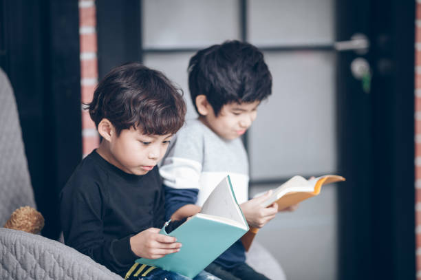 istock Group of young boy read a book in class room 1044550846