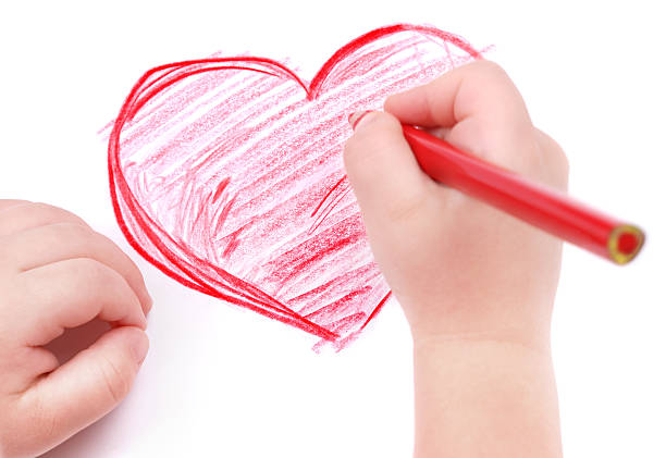 istock Childrens hand with pencil draws the heart 104455463