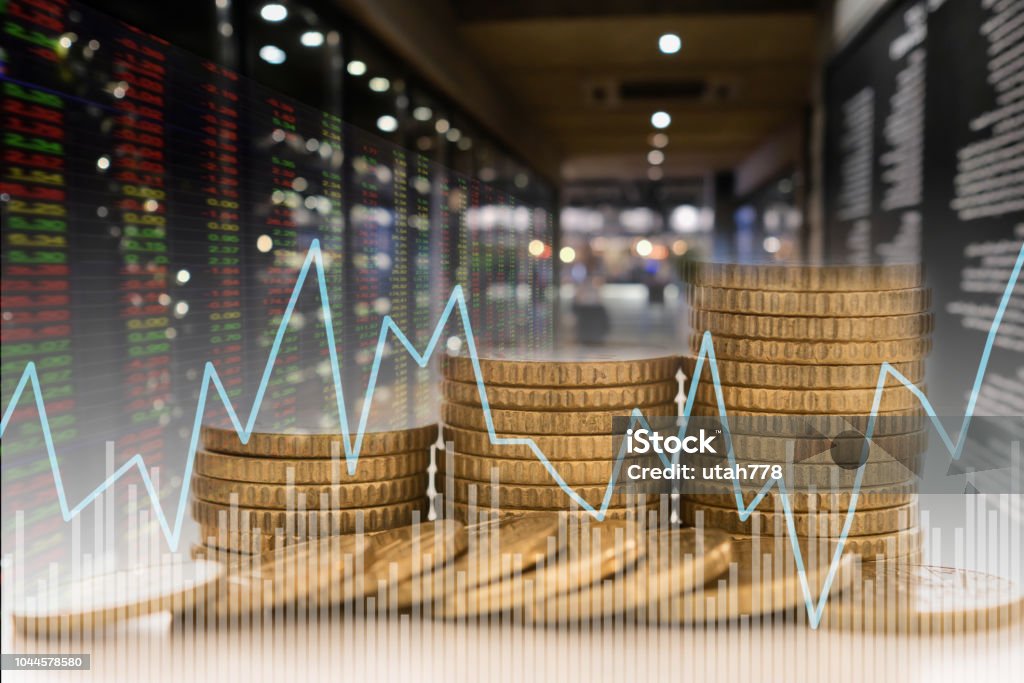investment finance Invest money and finance concept. coins stack with value index stock exchange with stock market graph and chart. Gold - Metal Stock Photo
