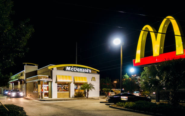 New Orleans, USA - Nov 29, 2017: McDonald's Family Restaurant drive-through and external car park. Night scene along Verterans Boulevard. McDonald's is now a global burger chain.