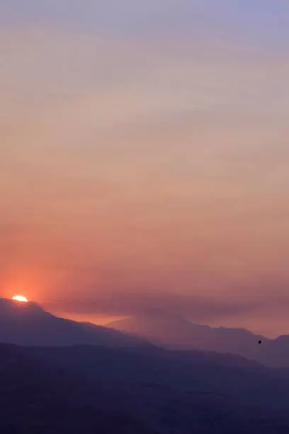 Sun peeking over hills during forest fire in Wenatchee National Forest