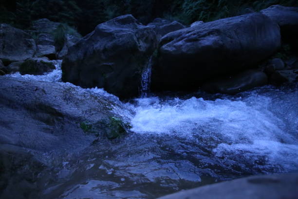 istock Amazing view of Water flowing between rocks in stream 1044617762