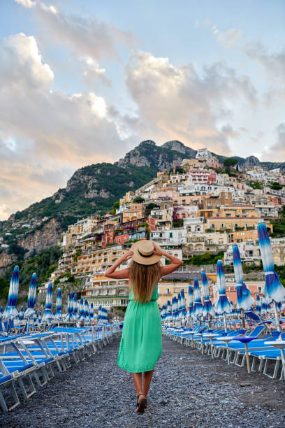 Young woman admiring the view of Positano village on Amalfi coast Italian vacations series. Young woman admiring the view of Positano village on Amalfi coast beauty in nature vertical africa southern africa stock pictures, royalty-free photos & images