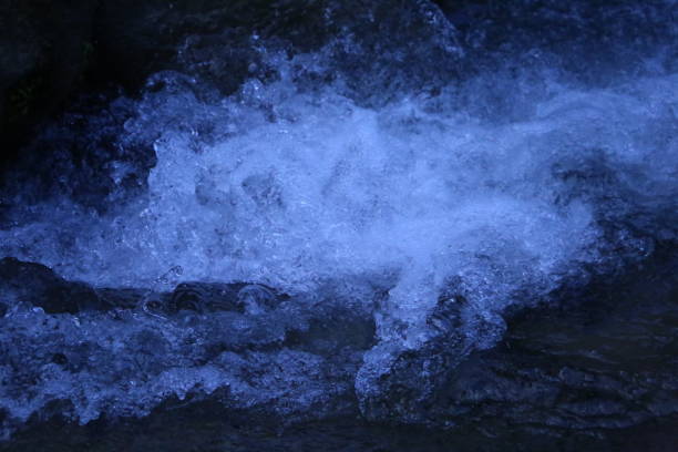 istock Pure crystal water spalsh with dark blue background in azad kashmir 1044617888