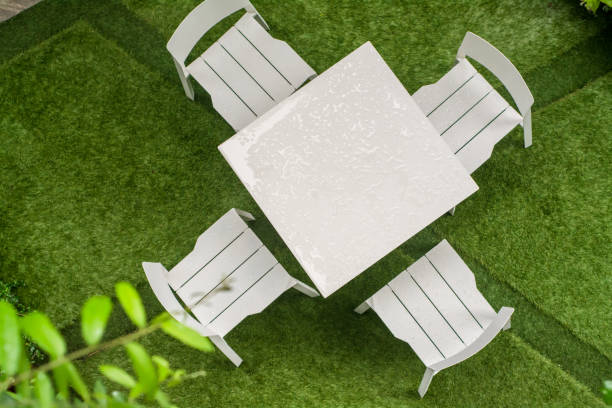istock green Garden patio with table and chairs after raining 1044623300