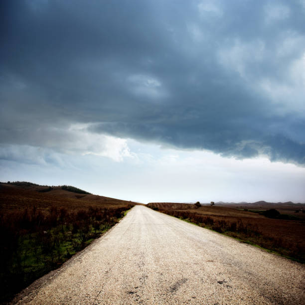 istock Empty countryside road over stormy sky 1044623624