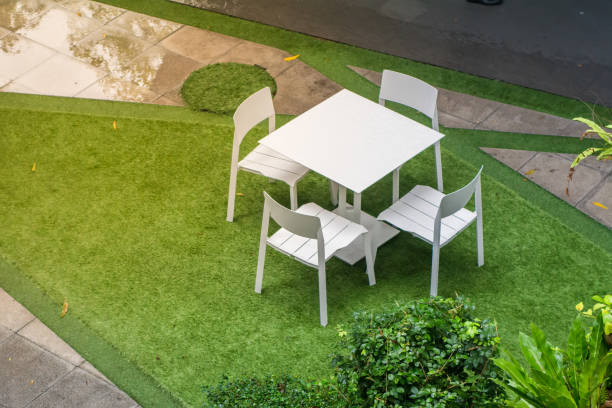 istock green Garden patio with table and chairs after raining 1044623726