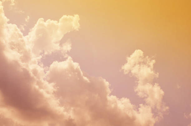 istock Nature background. Fluffy soft clouds in sky toned. 1044626518