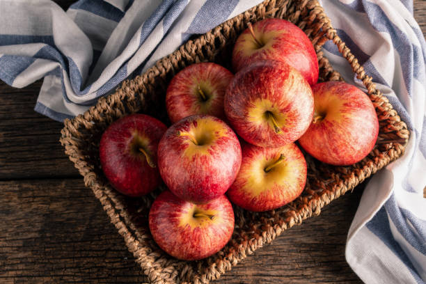 istock Fresh apples in basket on wood table 1044631888