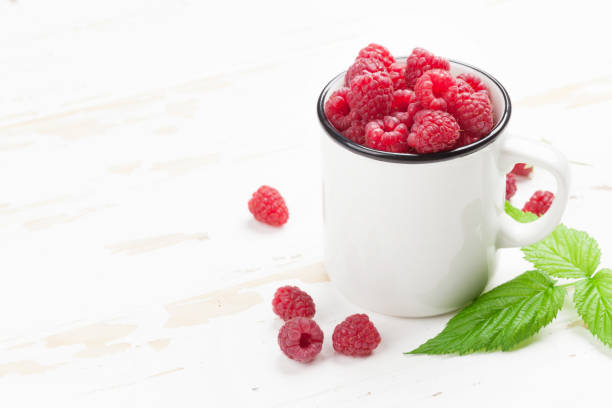 istock Cup of ripe raspberries 1044636900