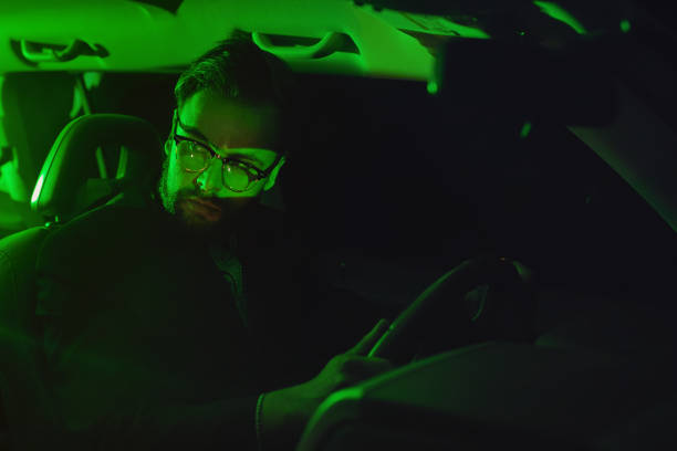 istock Businessman sitting in the car at night 1044642944