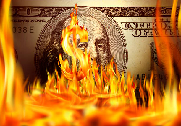 istock Burning dollar sign and fire flames over one hundred dollar bill 1044649118