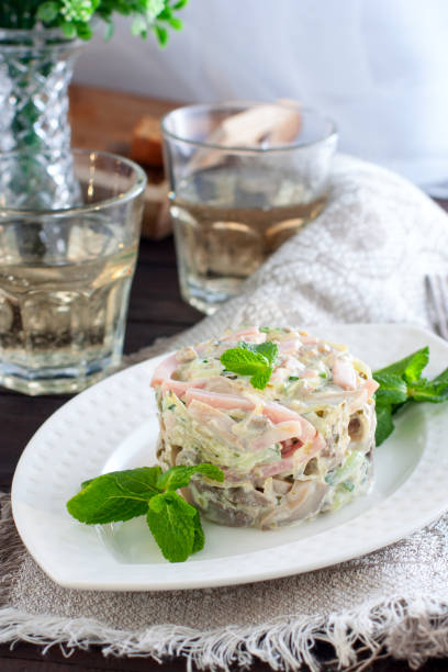 istock Salad with ham and mushrooms on white plate 1044649168