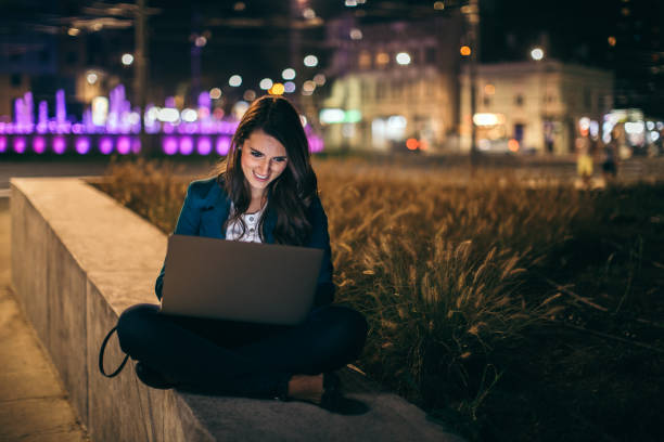 istock Young woman working outdoor at night 1044660086