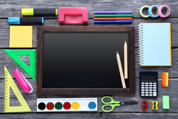 istock School supplies with black frame on wooden table 1044663848