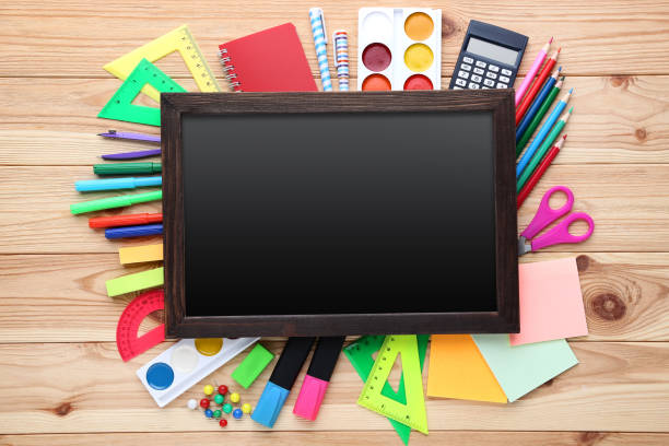 istock School supplies with black frame on wooden table 1044664660
