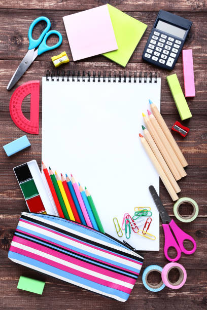 istock School supplies with blank sheet of paper on wooden table 1044666708